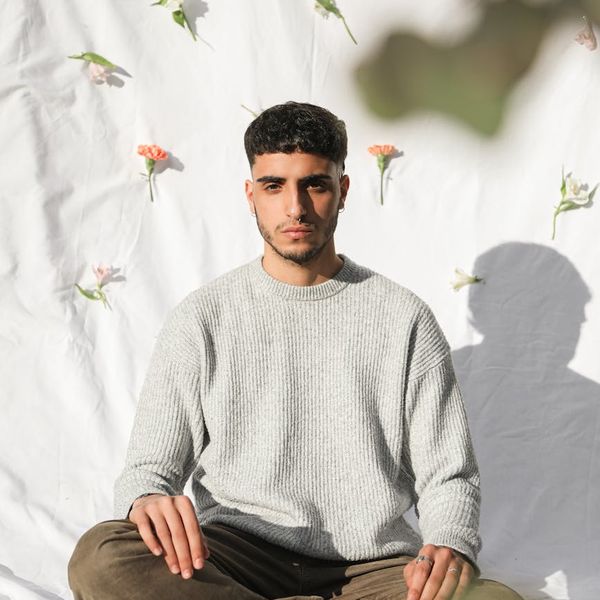 Silhouette of a person in a calm, meditative pose against a serene background.